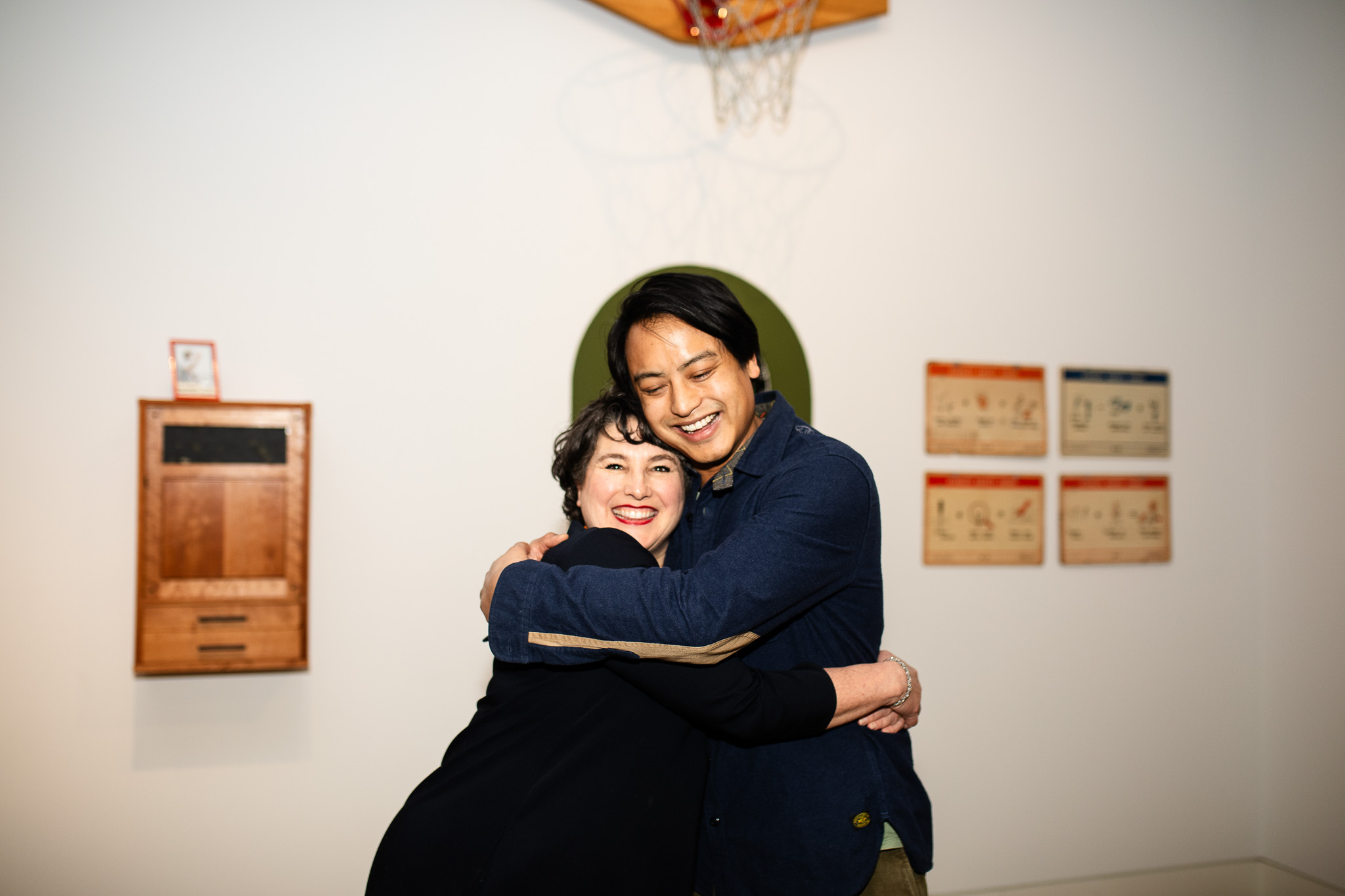 Artist presenting artwork to visitors in a contemporary museum gallery, illustrating how museums support artists and help grow their careers in East Hampton cultural institutions.